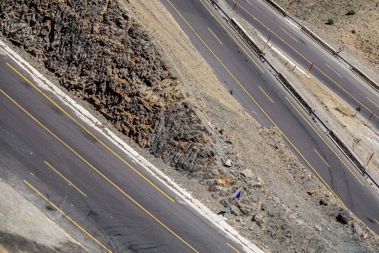Aerial view of a mountain highway winding through a remote landscape
