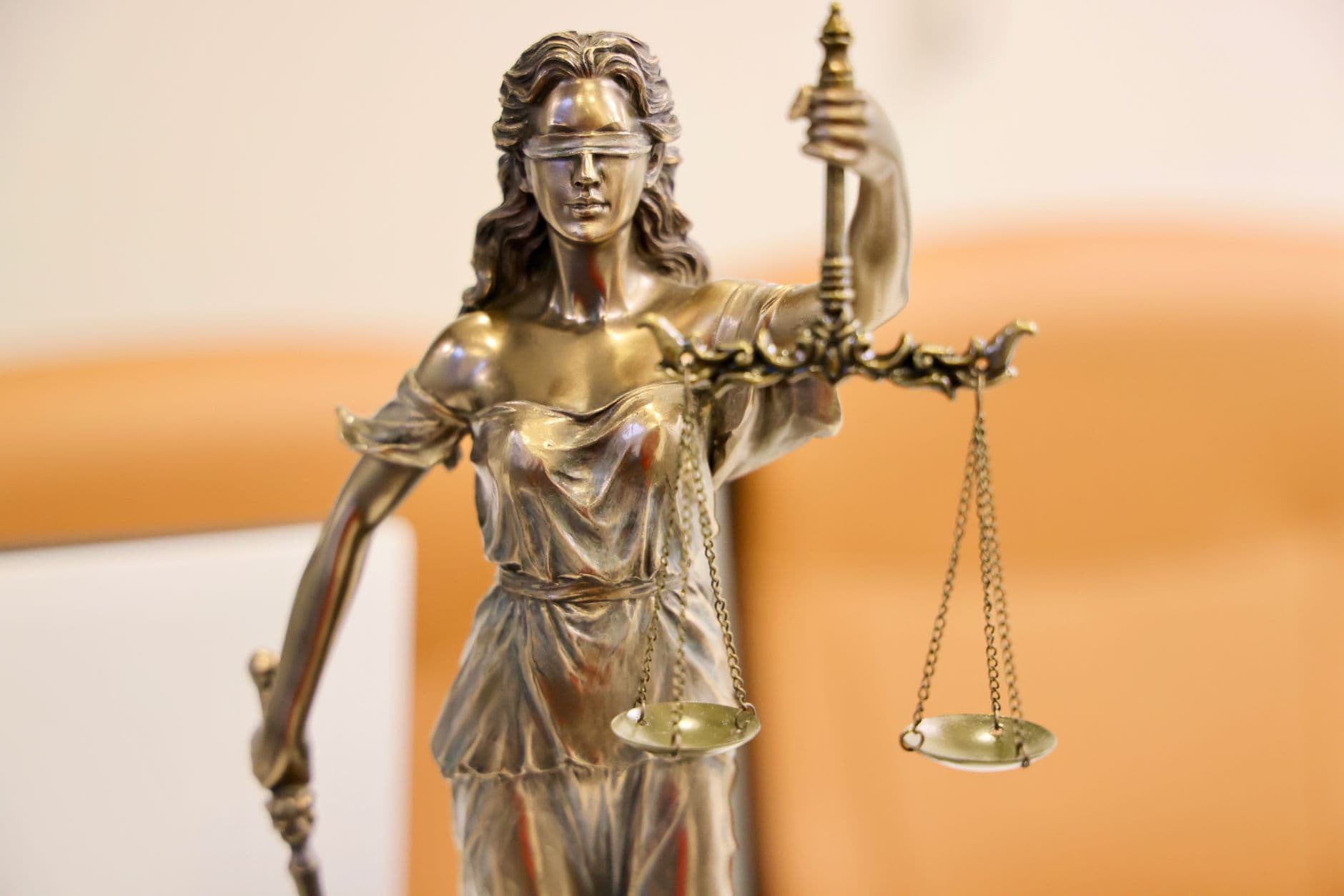 Statue of Lady Justice holding a set of scales, symbolizing law and constitutional authority