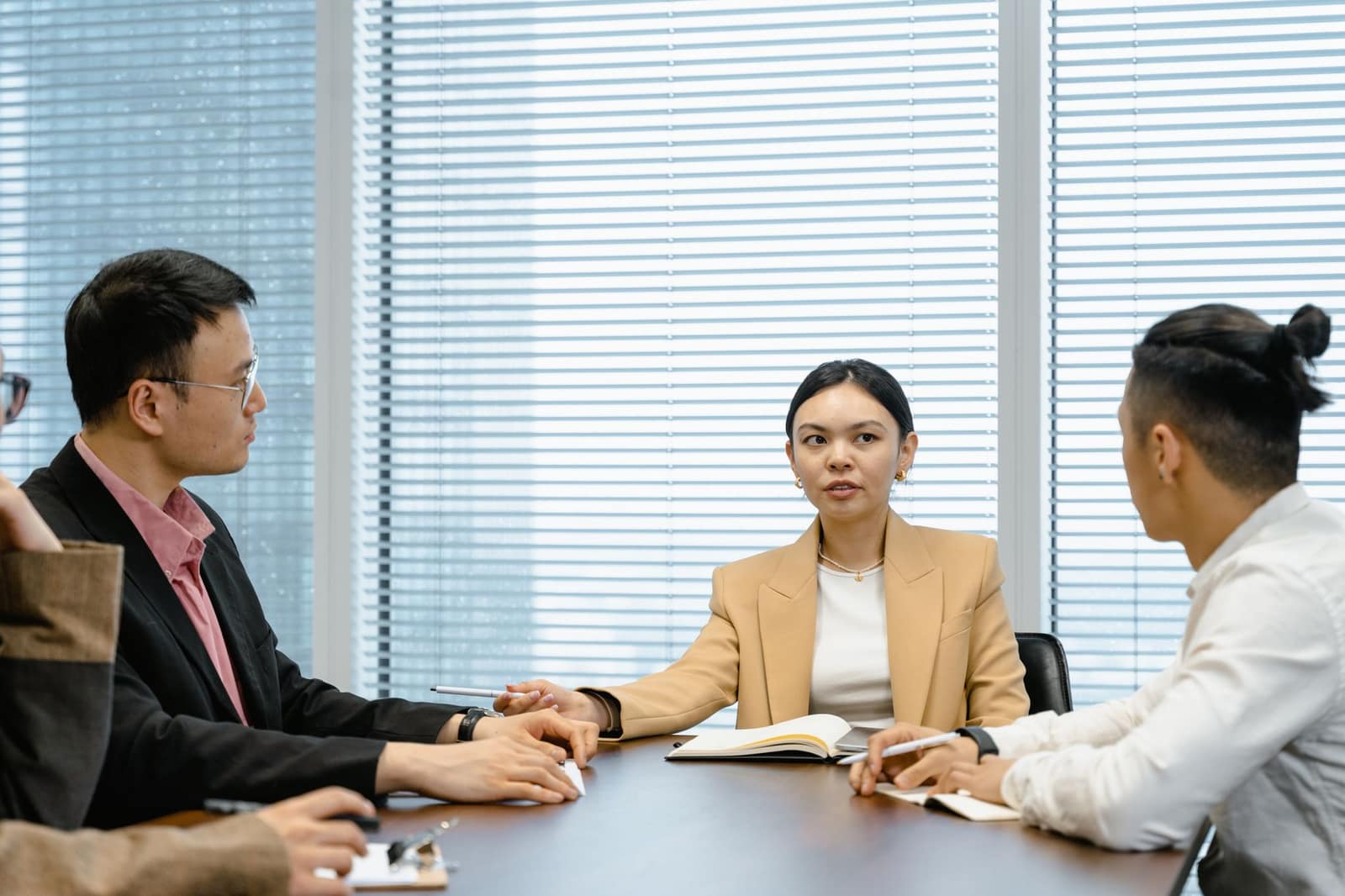 A diverse group of professionals seated around a conference table for a meeting