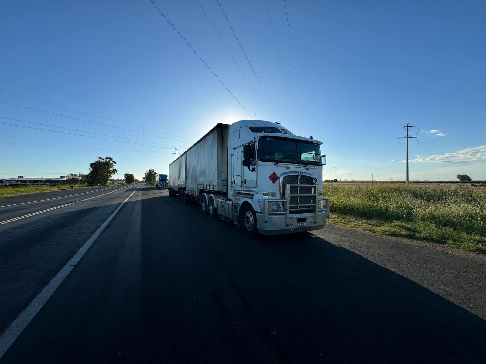 A semi truck carrying freight on an open highway