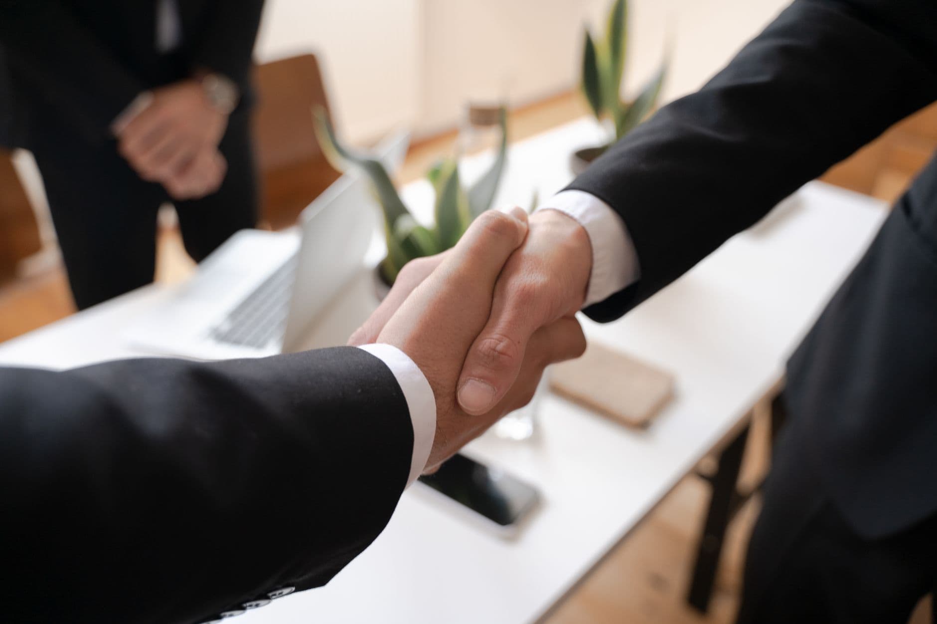 Close-up of a handshake between two professionals in a business setting