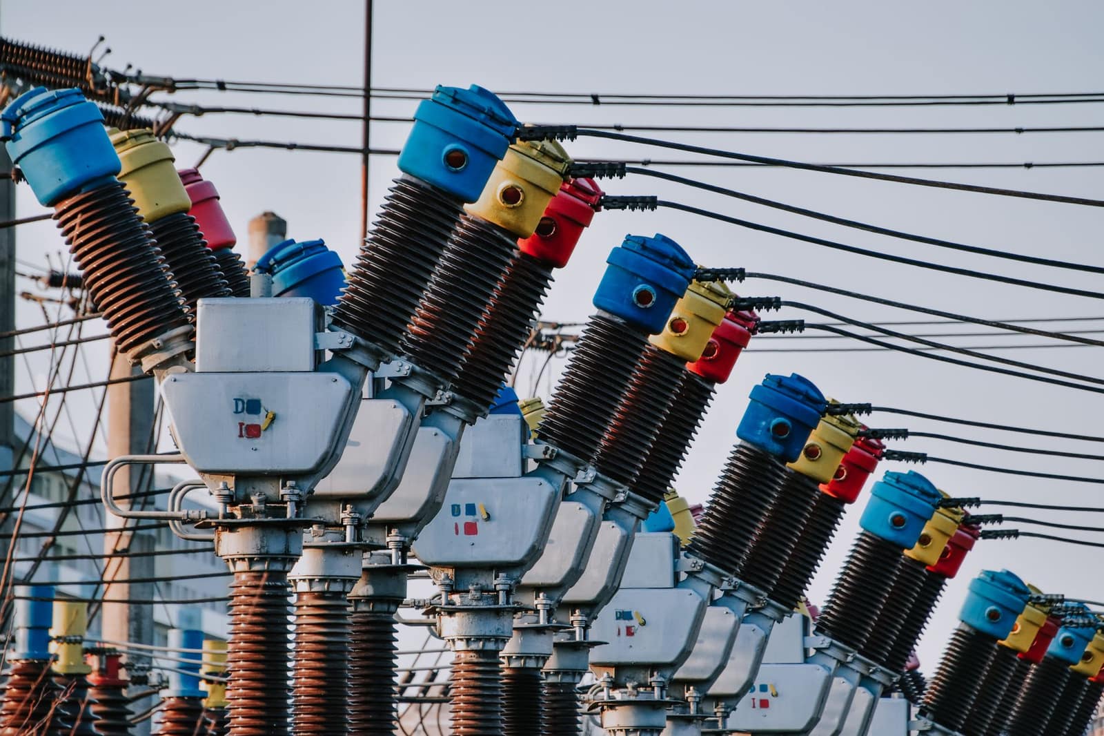 Close-up of colorful electrical transformers and wires at an outdoor power station