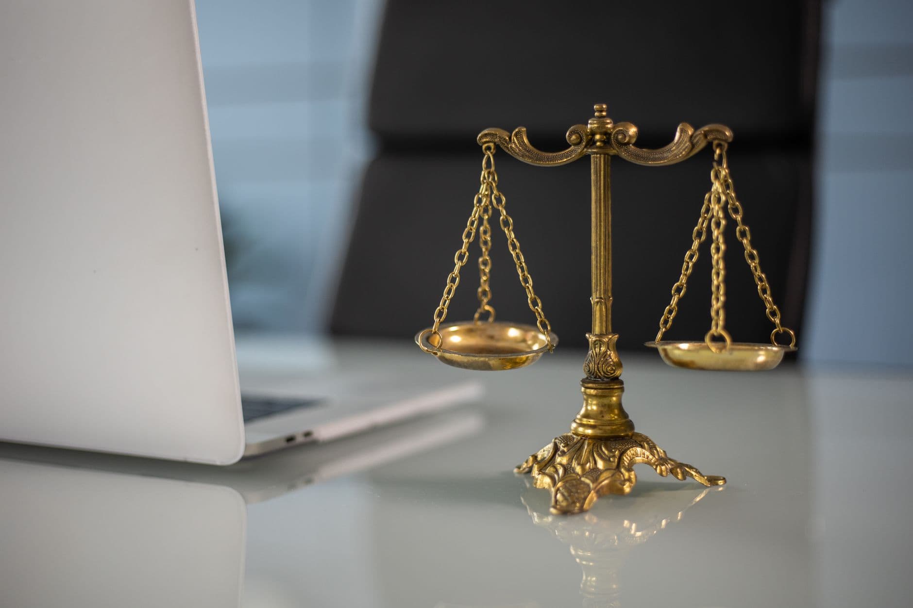Golden scales of justice resting on a desk