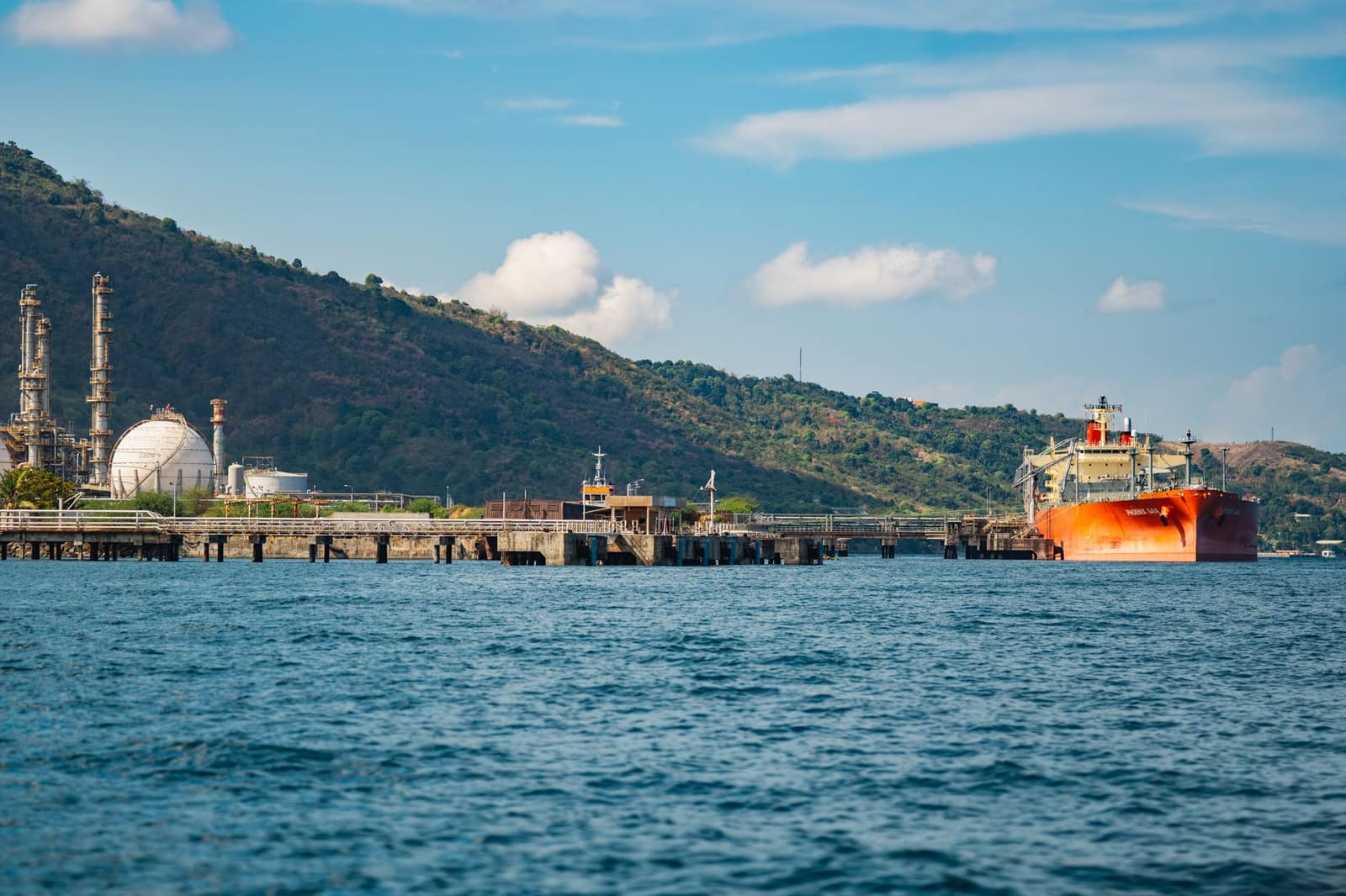An oil tanker docked at an industrial port