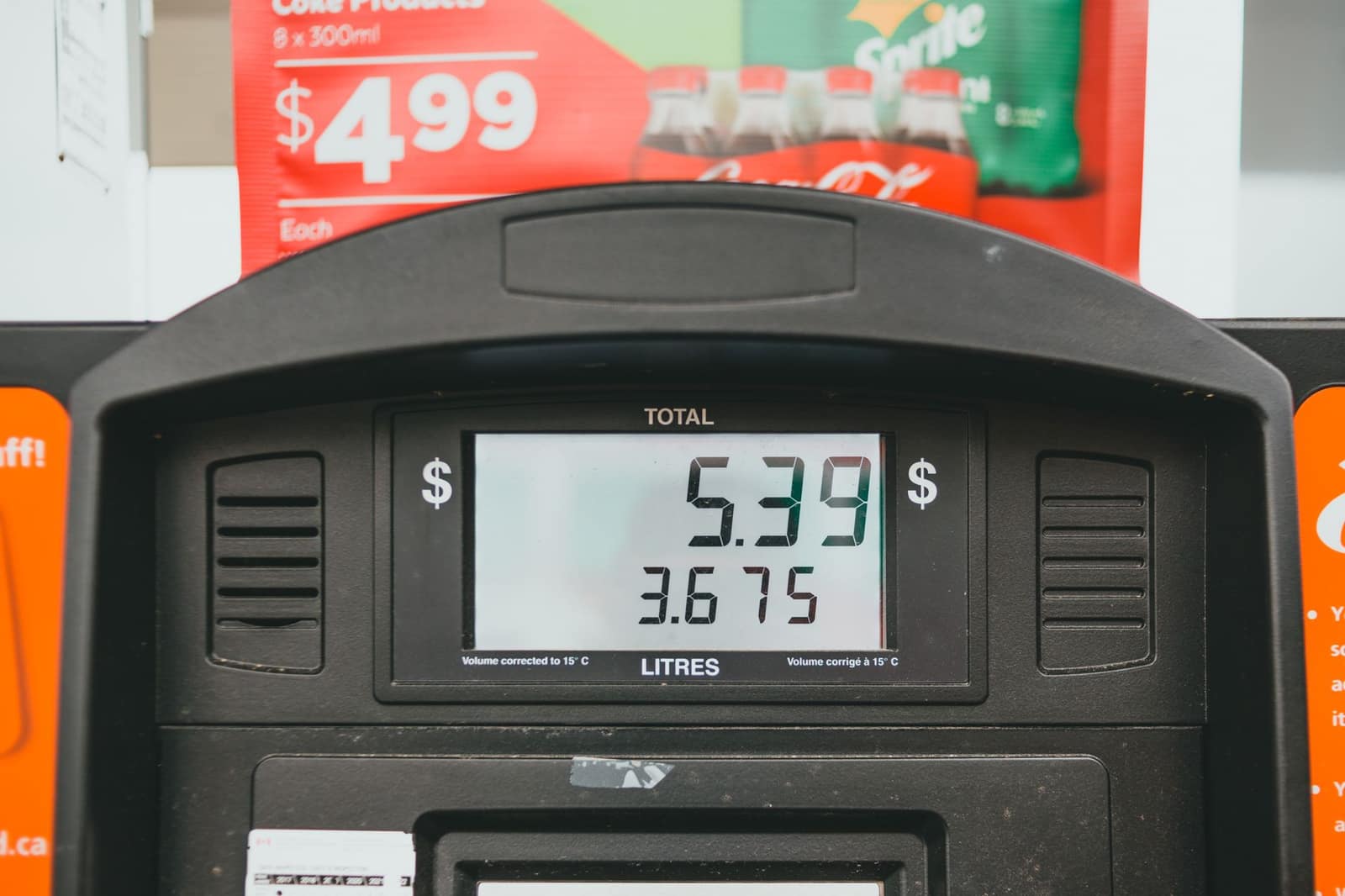 Close-up of a fuel pump display showing the price per litre during a refuelling transaction
